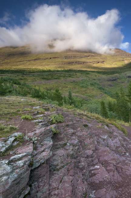 Distant mountain enclosed in clouds, Waterton Glacier International Peace Park, USA - Canada