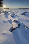 Sunrise on lake Kabetogama, viewing the snow-covered shoreline near Blue Fin Bay, Voyageurs National Park, Minnesota, USA